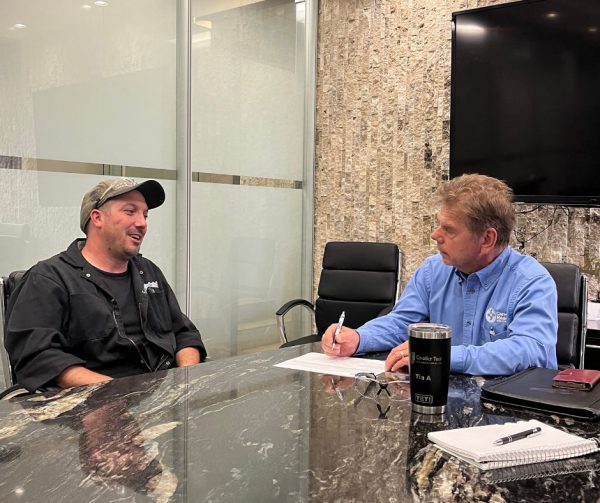 Nathan's trainer Chad smiling as he talks to Richard Janik about Nathan's technical objectives