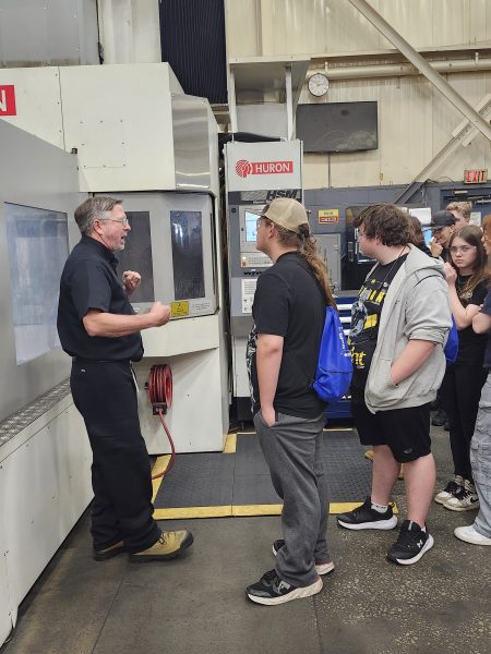 Plant Manager Larry Caron showing local students one of Cavalier's 5-axis CNC Machining Centres on Manufacturing Day.