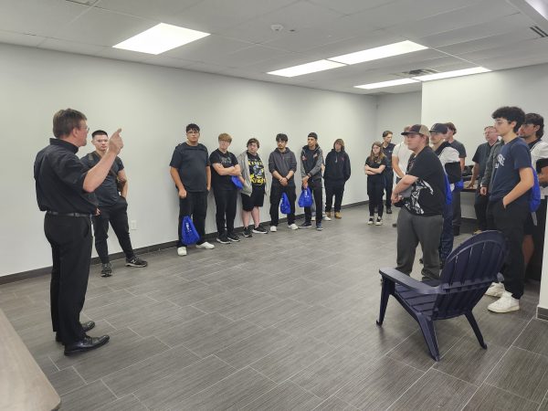 Sales Manager Peter Gossmann explaining VR to students on Manufacturing Day.