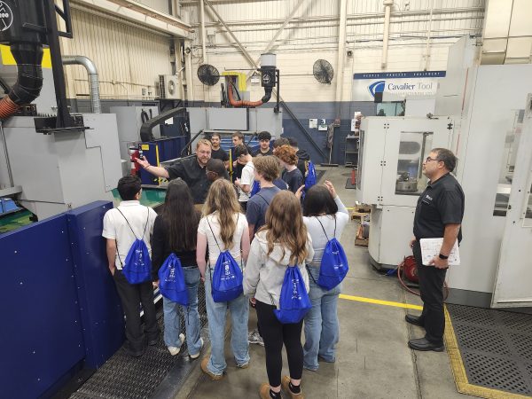 Program Manager Brian Remillong explaining EDM Technology to students on Manufacturing Day during Manufacturing Month.