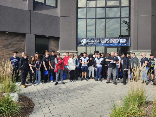 Students pose in front of the Cavalier Front Office on Manufacturing Day during Manufacturing Month.