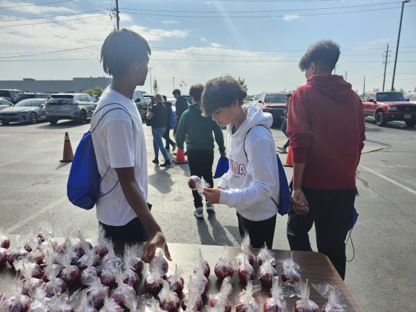 Students pick up their Cavalier Branded Candy Apple on Manufacturing Day.