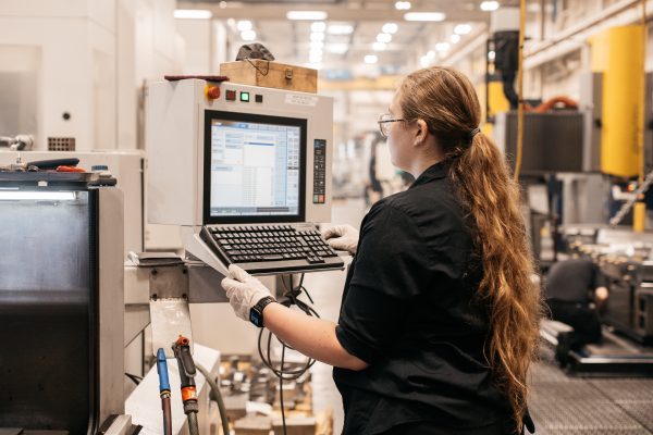 Cavalier Tool EDM Programmer Cynthia Cooper working on an EDM Machine.