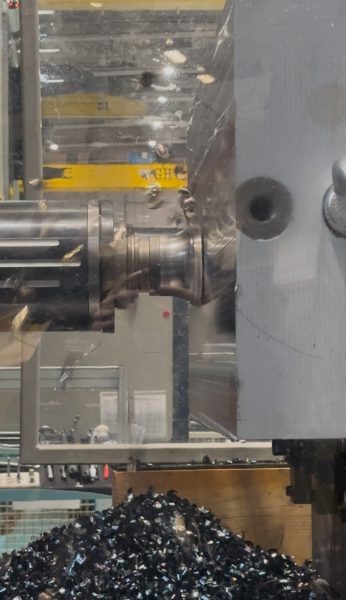 An close up image of a heavy duty roughing machine head. The Head is cutting a solid block of steel.